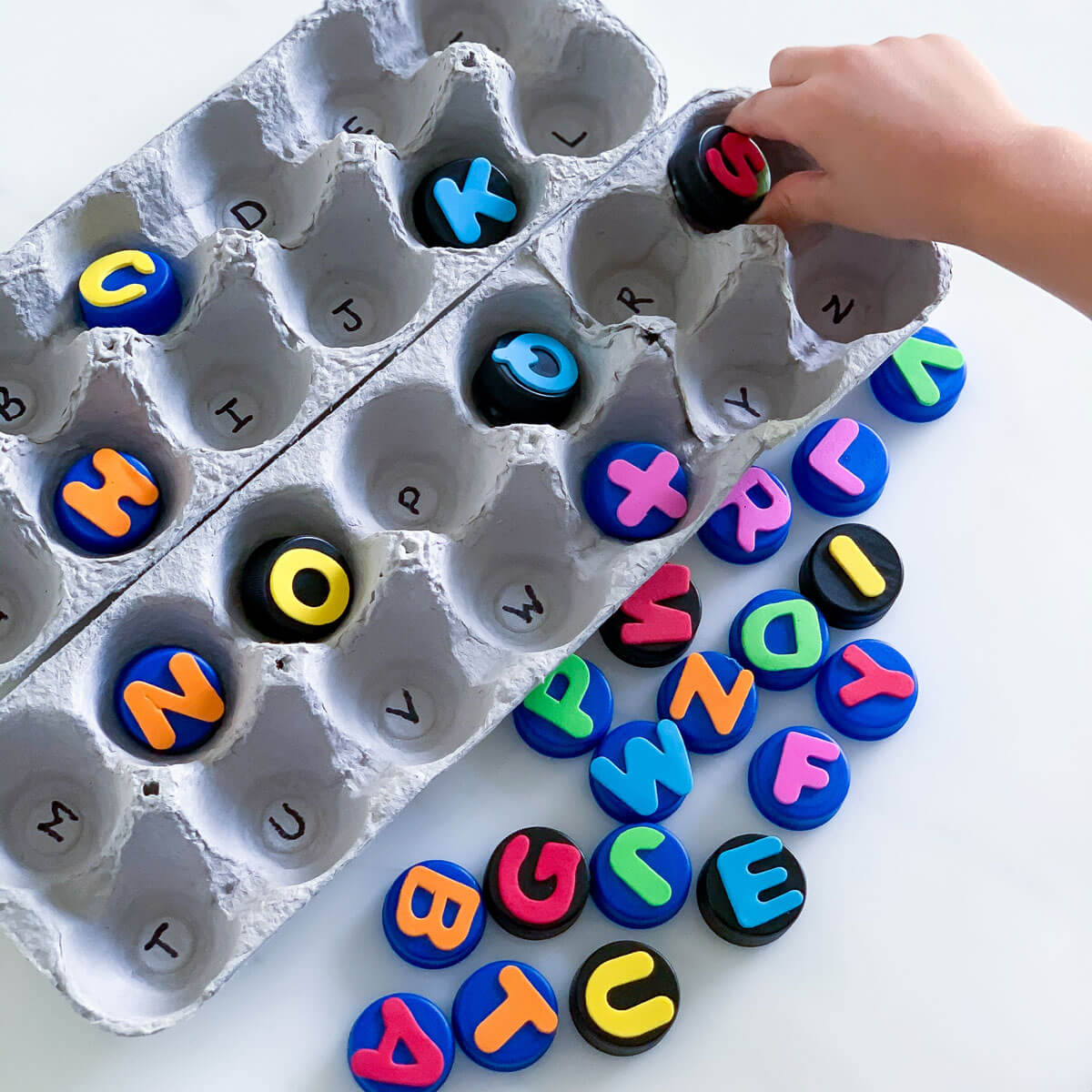 matching letter game using recycled egg carton bottle cap diy alphabet puzzle