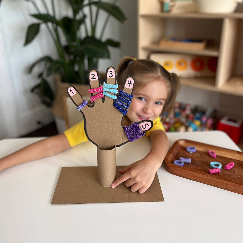 Unlock the fun of Counting to 5 with our engaging number recognition activity! Explore numbers 1 through 5 as little ones match hairbands to each finger of a playful cardboard hand, making learning a hands-on adventure.