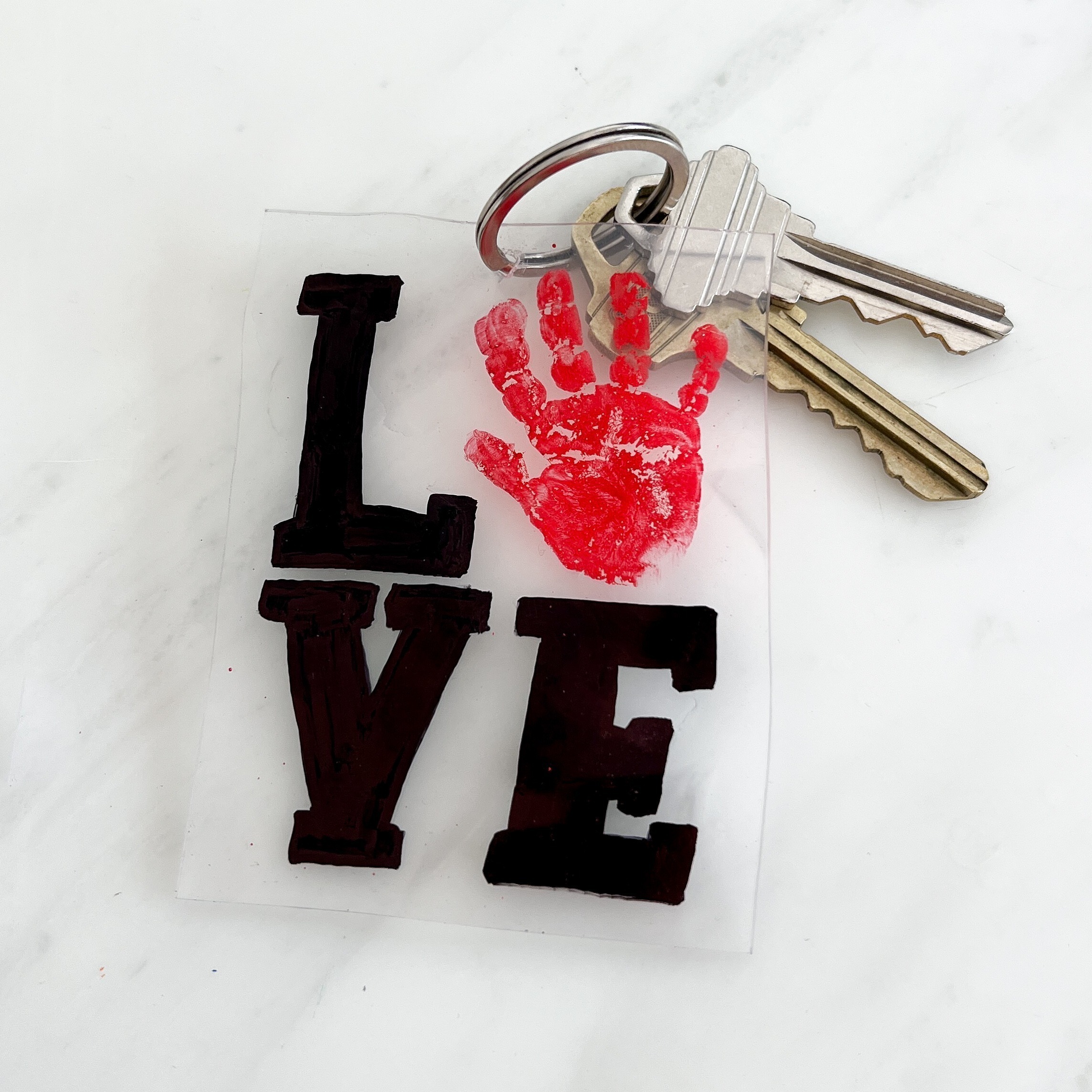 handprint craft for valentine's day using shrinky dink paper to make a keychain
