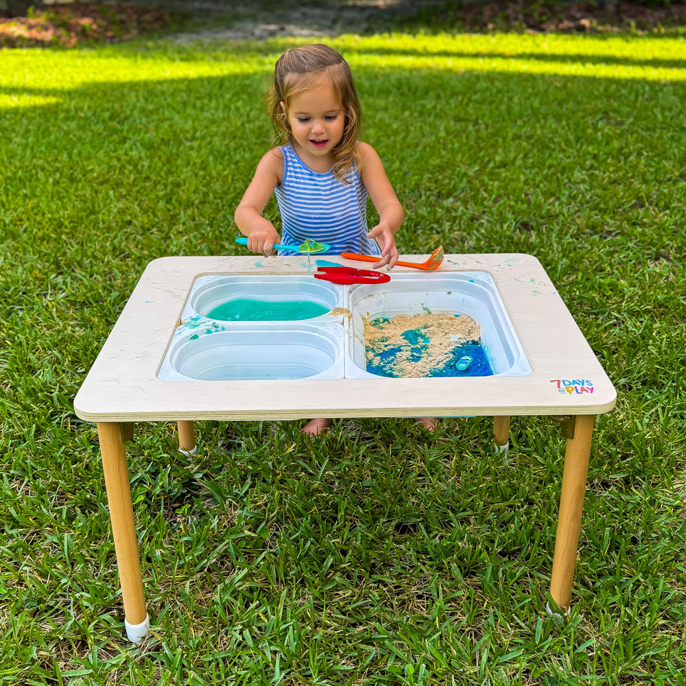 ocean sensory bin on activity table by 7 days of play. Child playing with marine creatures animals and taste safe jello for the ocean and cherros for the sand. great activity for toddlers