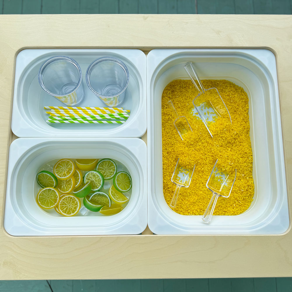 lemonade sensory bin in foldable sensory table by 7 days of play
