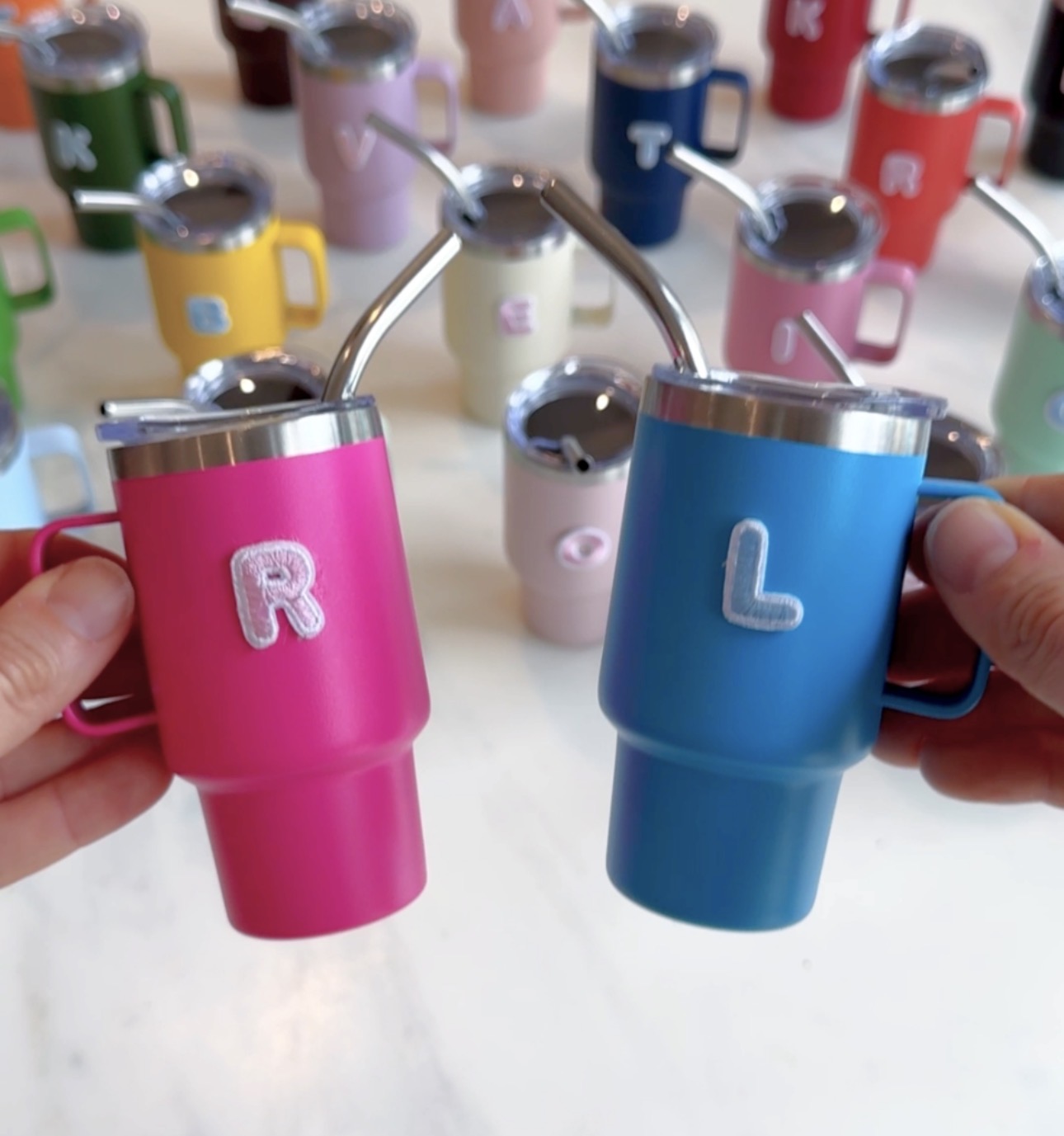 DIY Personalized Mini Tumblers for Valentine’s Day Class Gifts DIY personalized mini tumblers with straws in bright colors, each cup featuring a child’s initial, used as a Valentine’s Day class gift