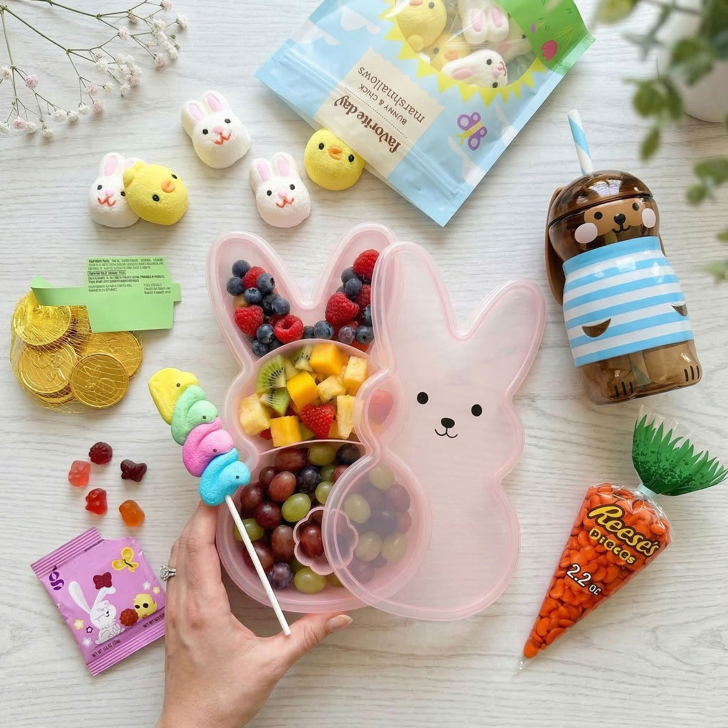 Easter Snacks for Kids and Easter Basket Treat Ideas Easter snacks for kids with bunny snack container filled with fruit, candy, marshmallows, and Easter treats